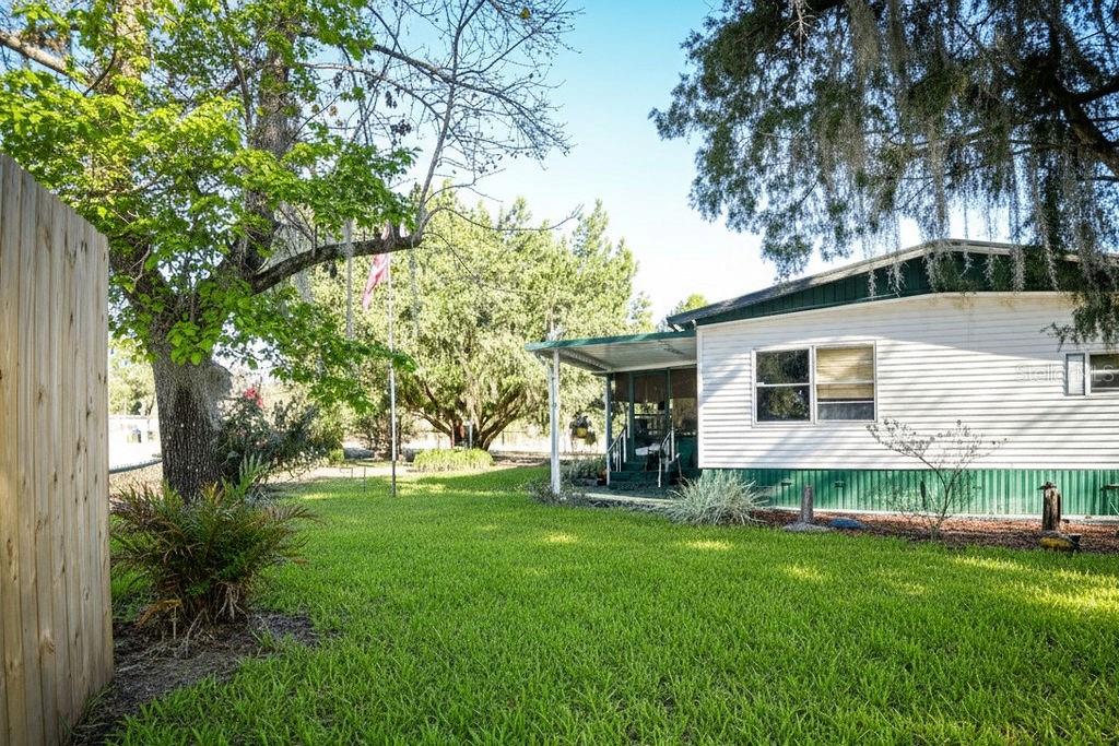 240 Kitty Avenue Interlachen, FL 32148 - Photo 41 of 44 a backyard of a house with table and chairs
