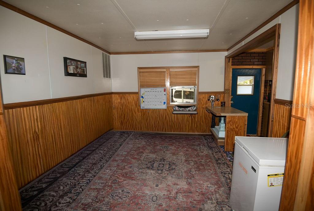 240 Kitty Avenue Interlachen, FL 32148 - Photo 9 of 44 a view of a livingroom with furniture wooden floor and windows