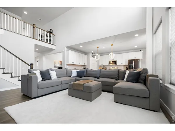 a living room with furniture and a ceiling fan