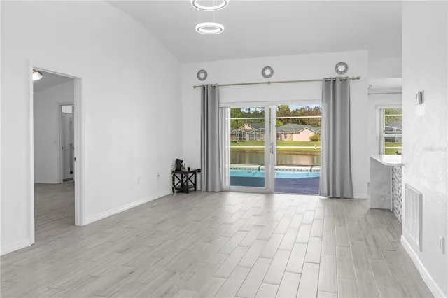 a view of empty room with wooden floor