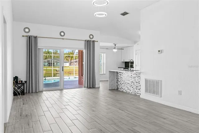 a kitchen with stainless steel appliances kitchen island granite countertop a refrigerator and a stove top oven