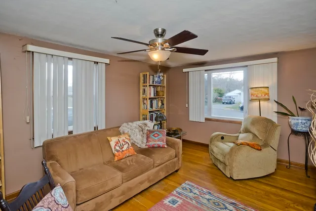 a living room with furniture and a ceiling fan