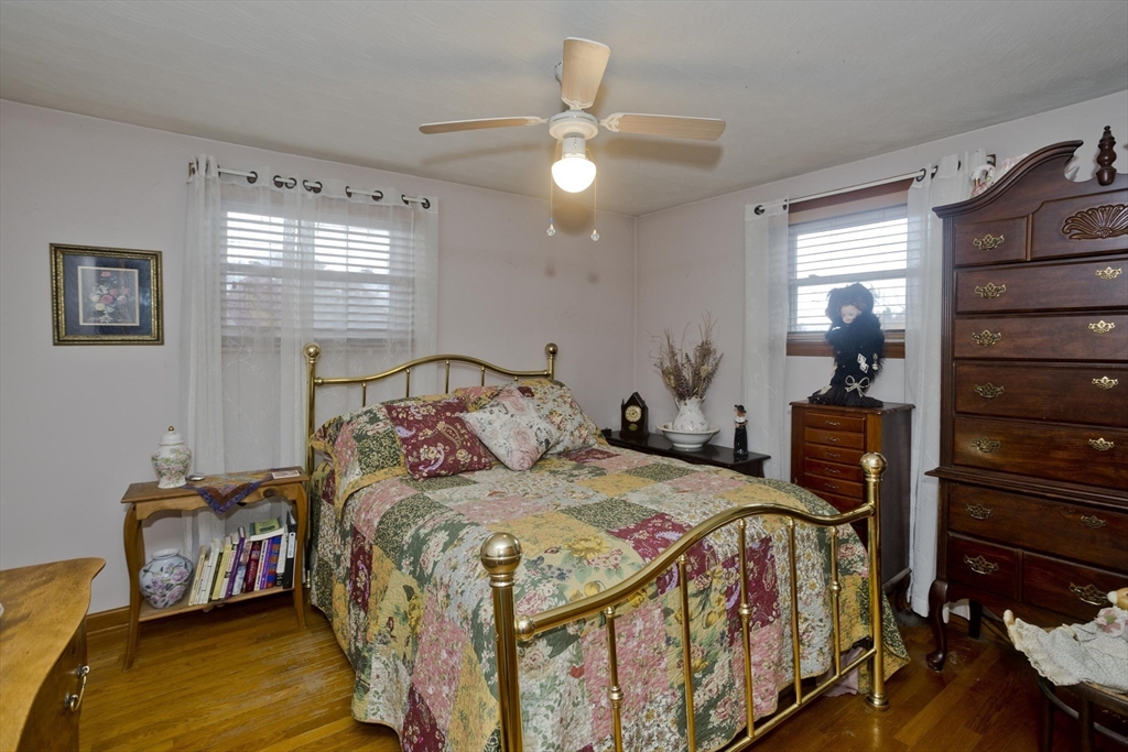 27 Regal Street Springfield, MA 01118 - Photo 22 of 32 a bedroom with a bed and a chandelier
