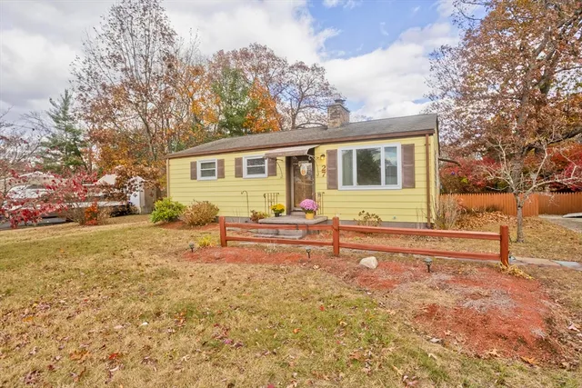 a view of a house with backyard and sitting area