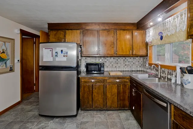 a kitchen with a sink and a refrigerator