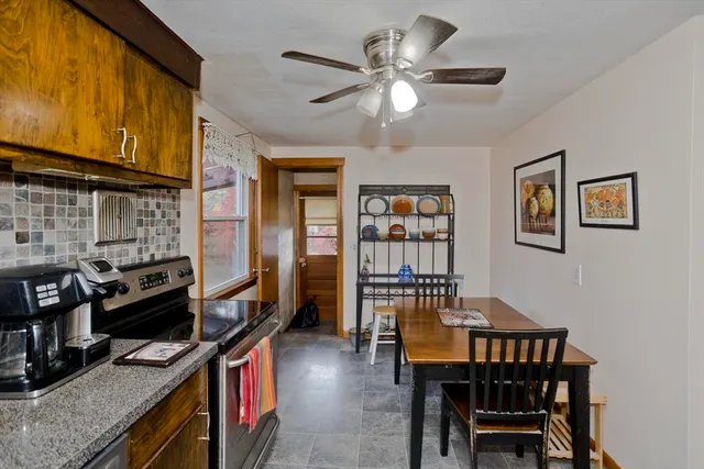 a view of a dining room with furniture and a kitchen