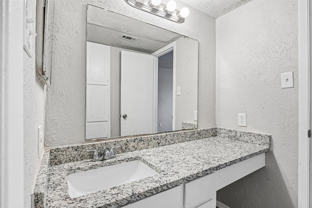 5534 Boca Raton Boulevard, Unit 292 Fort Worth, TX 76112 - Photo 23 of 31 a bathroom with a granite countertop sink and a mirror