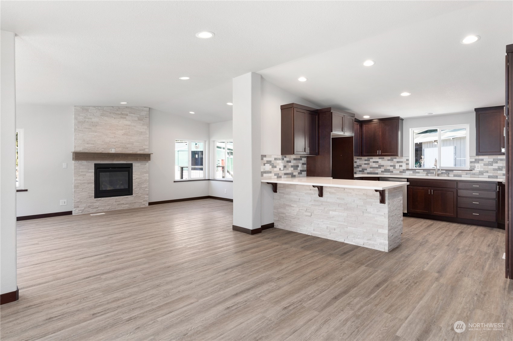 4656 Monkey Hill Road Oak Harbor, WA 98277 - Photo 32 of 40 a large kitchen with stainless steel appliances kitchen island granite countertop a large counter top and a stove