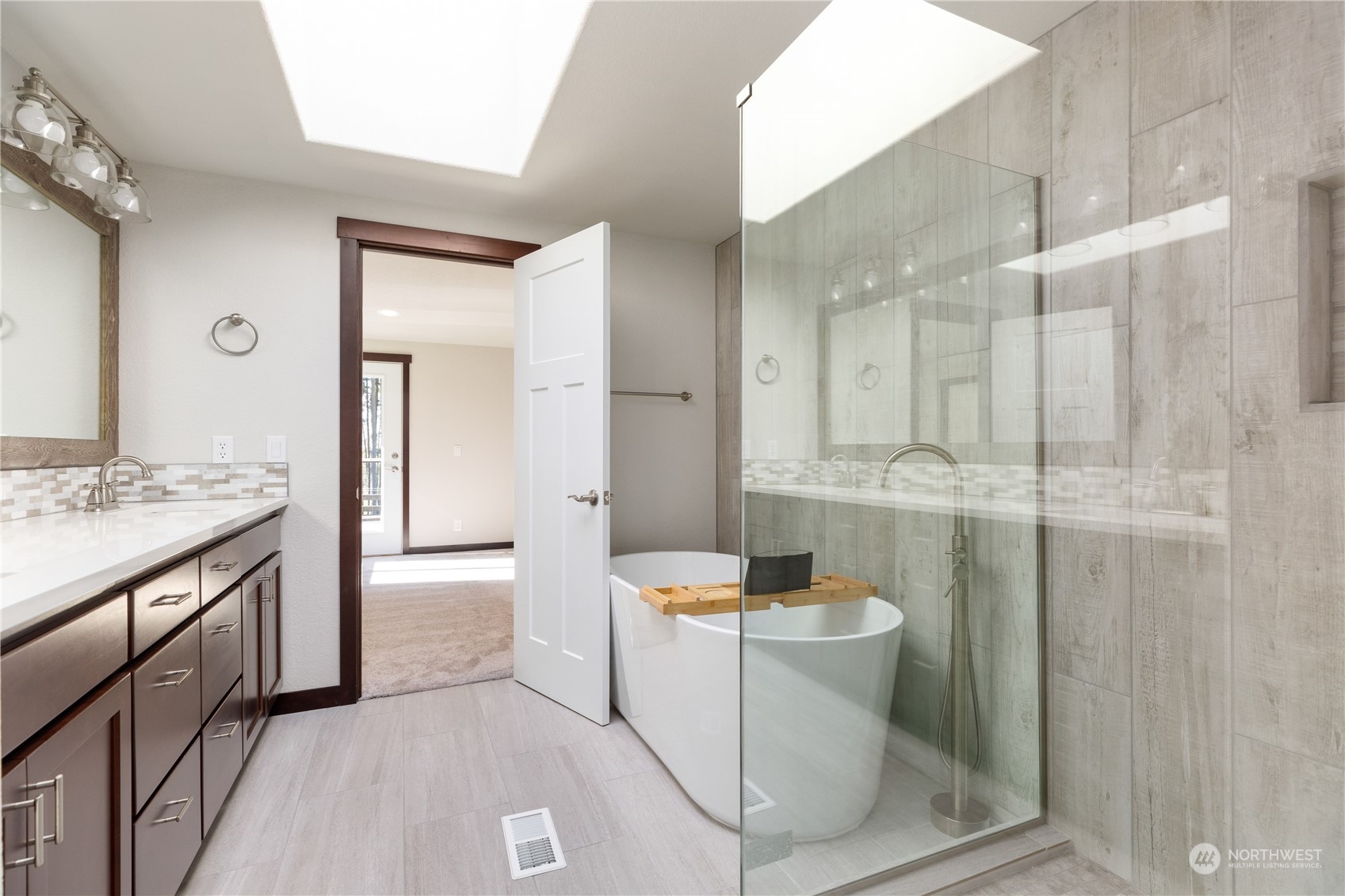 4656 Monkey Hill Road Oak Harbor, WA 98277 - Photo 35 of 40 a bathroom with a granite countertop sink a toilet a mirror and shower