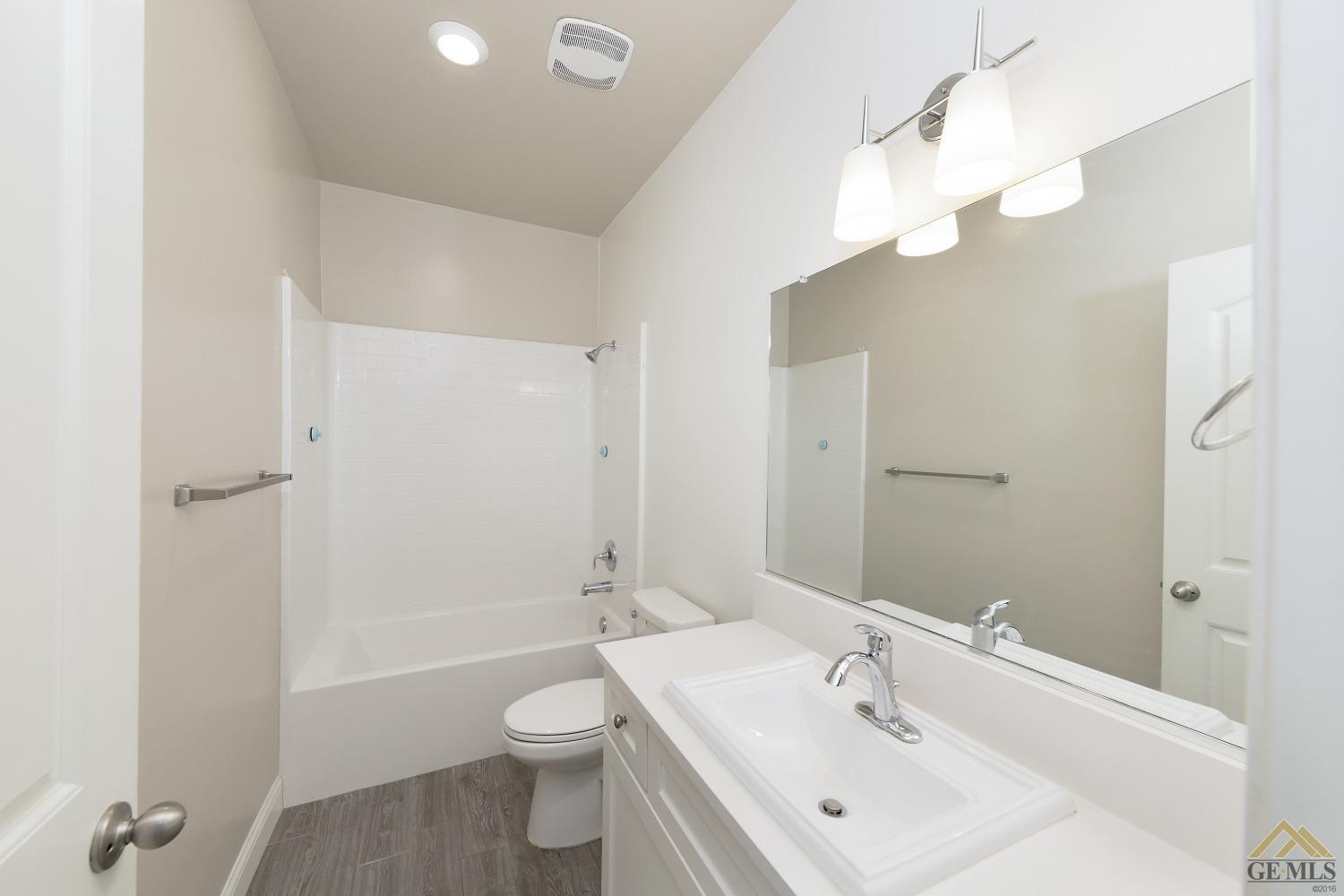 Undisclosed Address Shafter, CA 93263 - Photo 14 of 36 a bathroom with a sink a toilet and shower