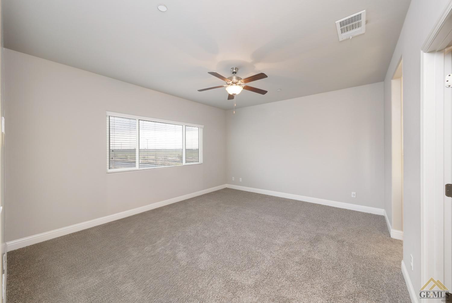 Undisclosed Address Shafter, CA 93263 - Photo 19 of 36 an empty room with a window and a ceiling fan