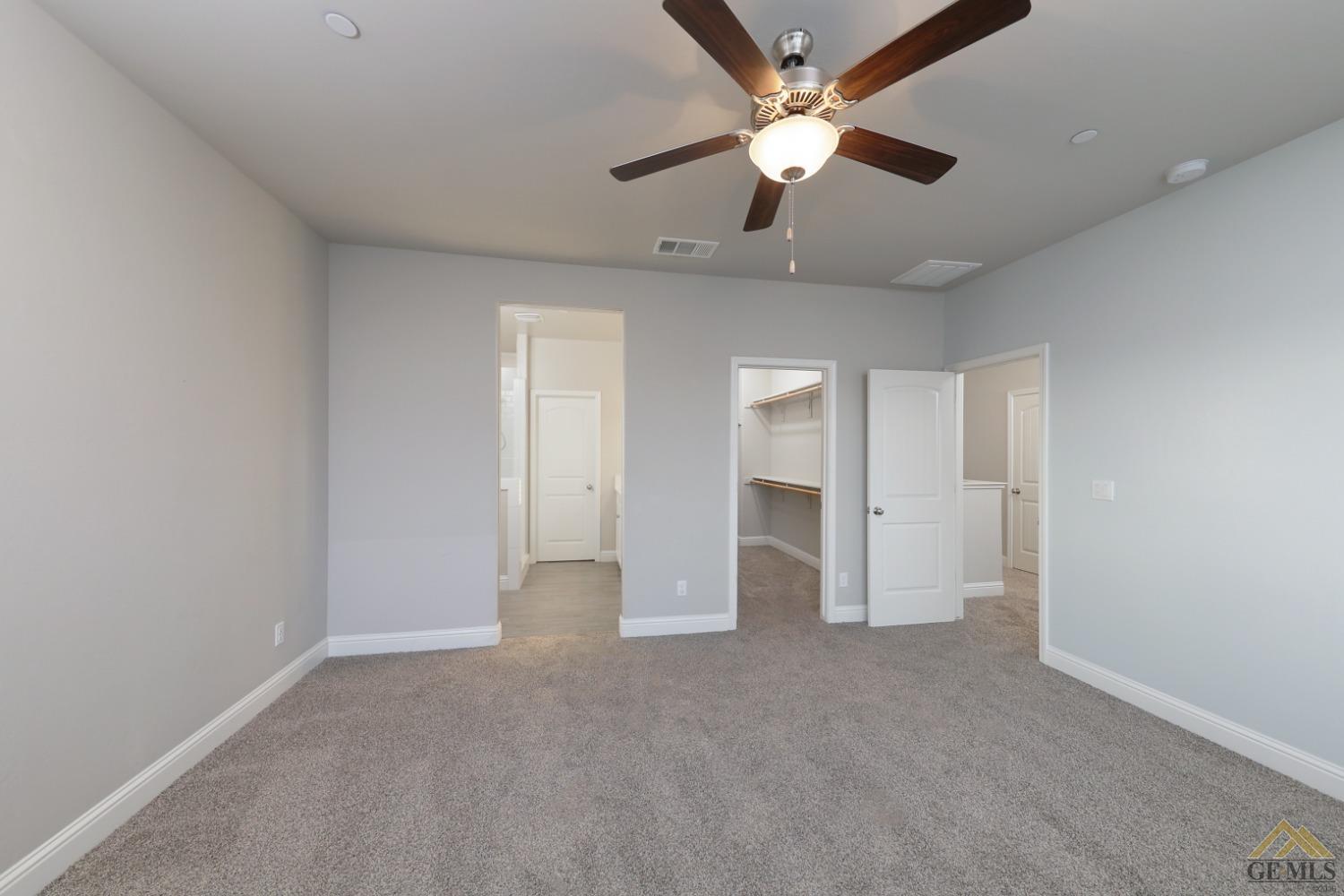 Undisclosed Address Shafter, CA 93263 - Photo 23 of 36 an empty room with chandelier fan and windows