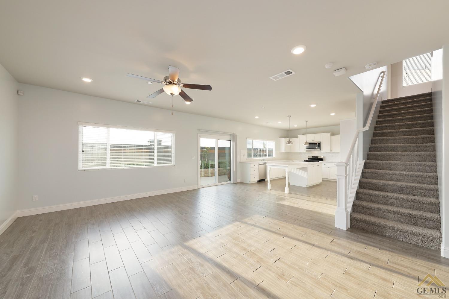 Undisclosed Address Shafter, CA 93263 - Photo 25 of 36 a view of an empty room with wooden floor and a window