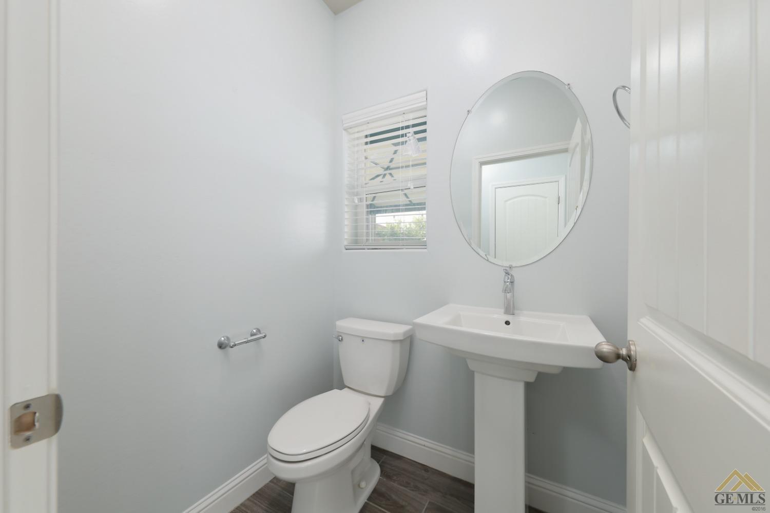 Undisclosed Address Shafter, CA 93263 - Photo 29 of 36 a bathroom with a toilet sink and mirror