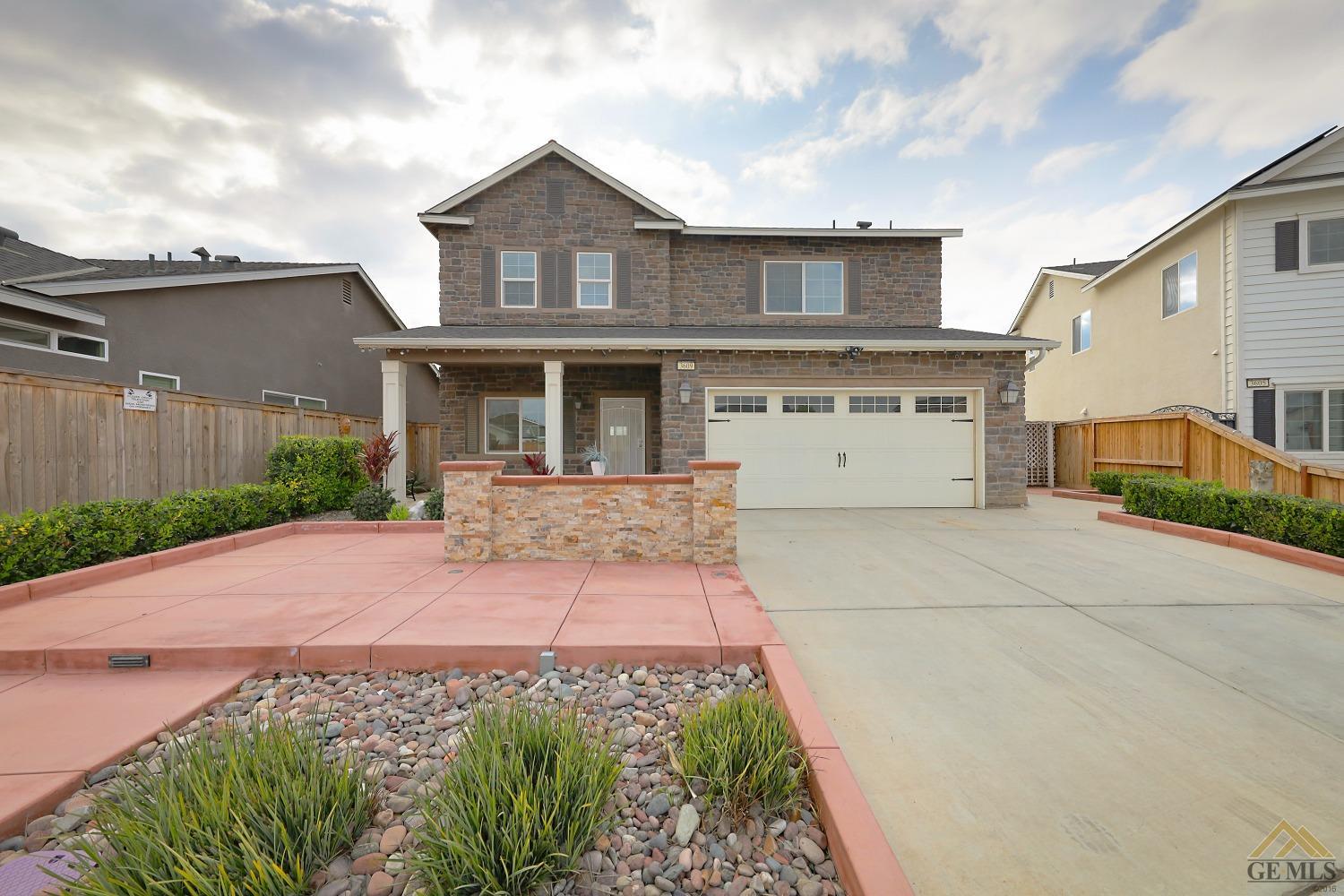 Undisclosed Address Shafter, CA 93263 - Photo 3 of 36 a front view of a house with a yard and a garage