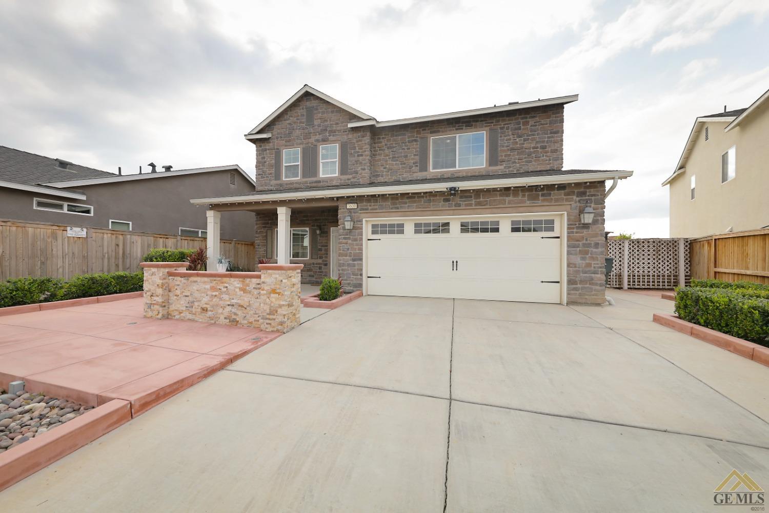Undisclosed Address Shafter, CA 93263 - Photo 4 of 36 a front view of a house with a yard and garage