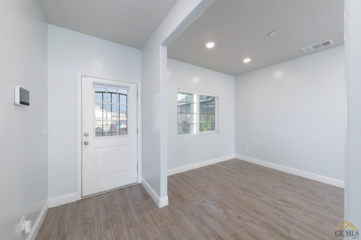 Undisclosed Address Shafter, CA 93263 - Photo 6 of 36 an empty room with wooden floor and windows