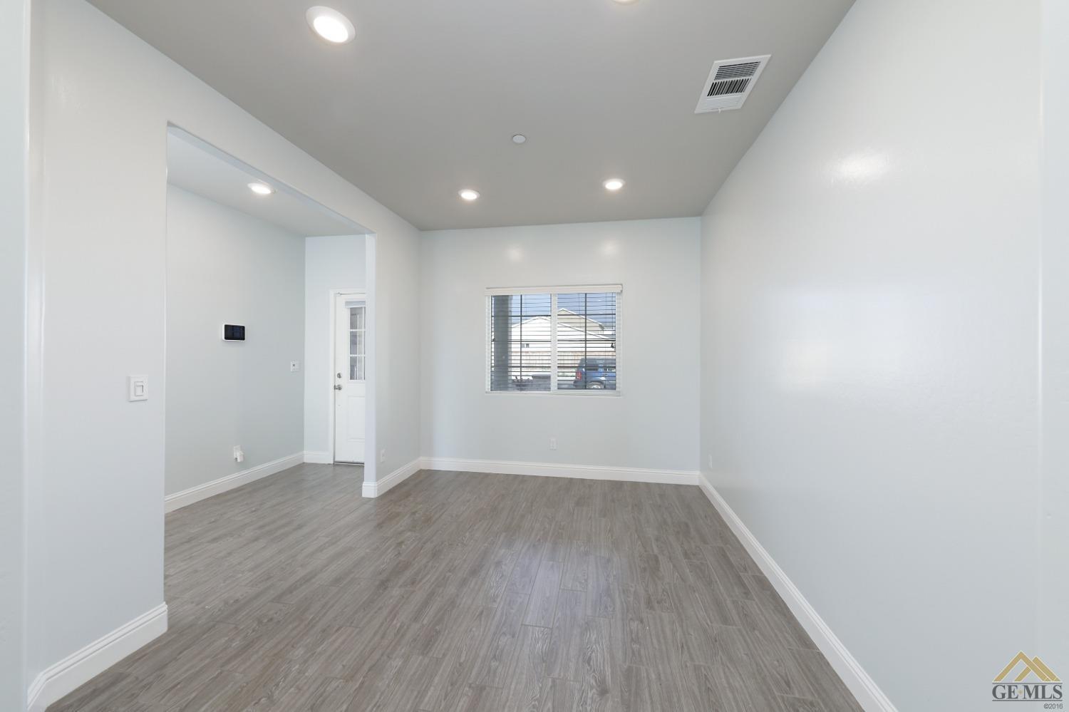 Undisclosed Address Shafter, CA 93263 - Photo 8 of 36 a view of an empty room with wooden floor