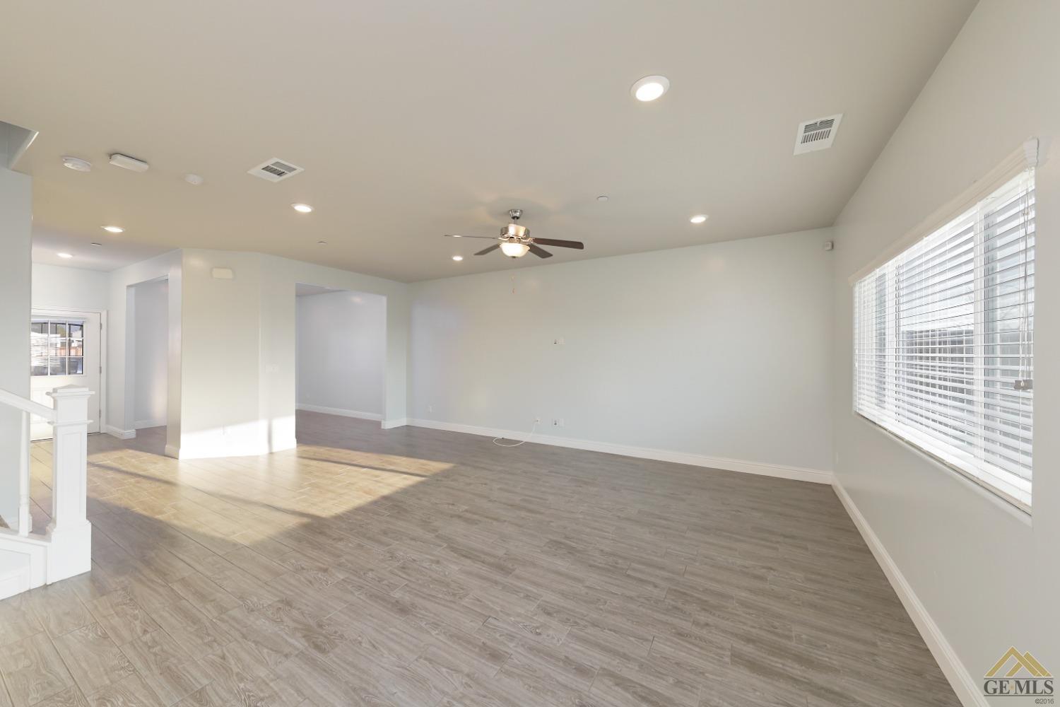 Undisclosed Address Shafter, CA 93263 - Photo 9 of 36 a view of an empty room with wooden floor and a window