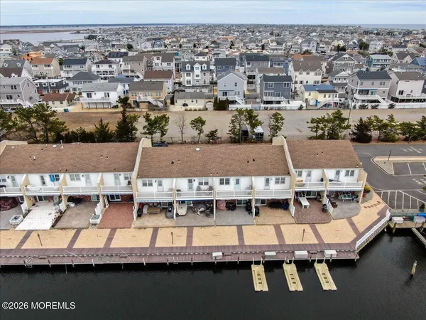 an aerial view of residential houses with outdoor space and swimming pool