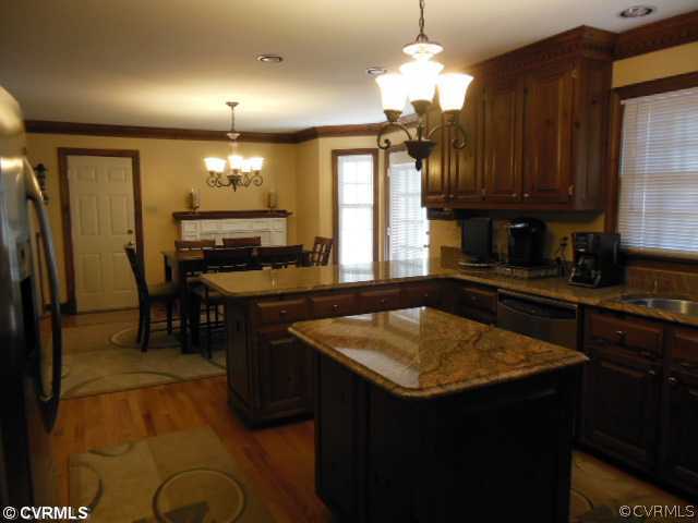 208 Rivers Bend Circle Chester, VA 23836 - Photo 15 of 24 Kitchen - The kitchen has a gas fireplace on the b
