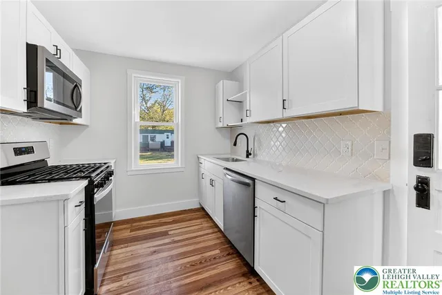 a kitchen with granite countertop a sink and a stove top oven