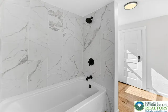 a bathroom with a bathtub and a shower