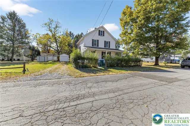 a view of swimming pool with outdoor seating and house in the background