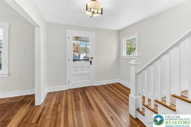 a view of an entryway with wooden floor