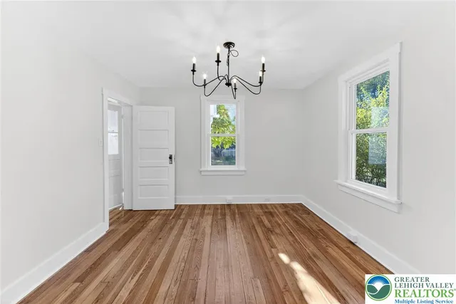 a view of room with window and hardwood floor