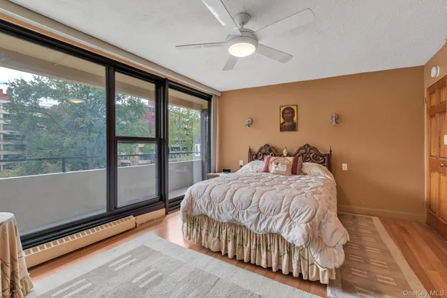 a bed sitting in a spacious bedroom next to a window