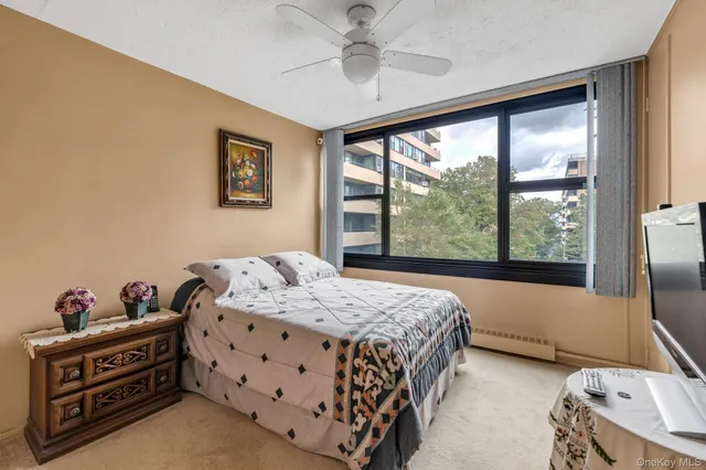a bedroom with a bed and a large window