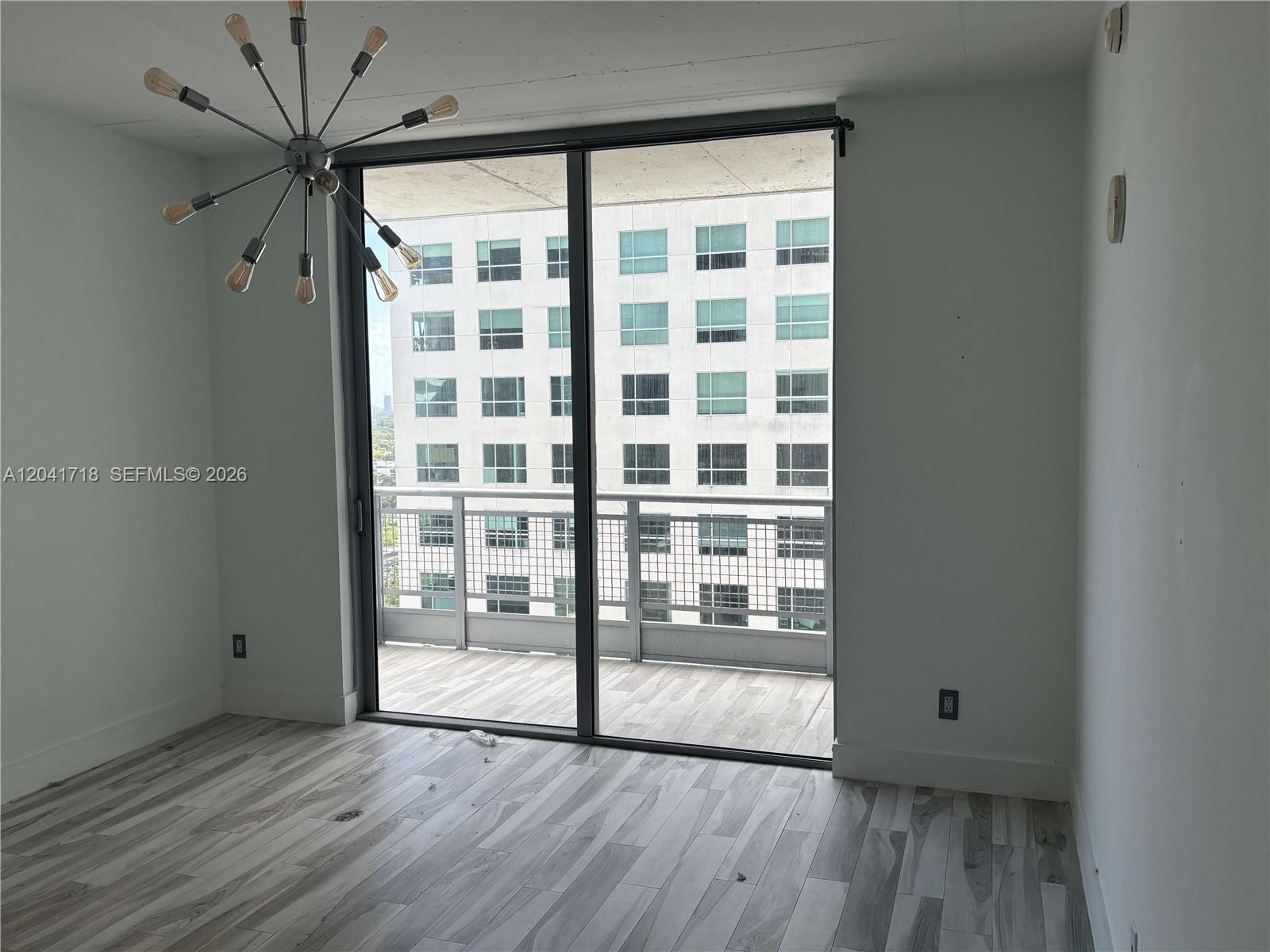 690 Southwest 1st Court, Unit 2124 Miami, FL 33130 - Photo 15 of 20 a view of a big room with wooden floor and a window