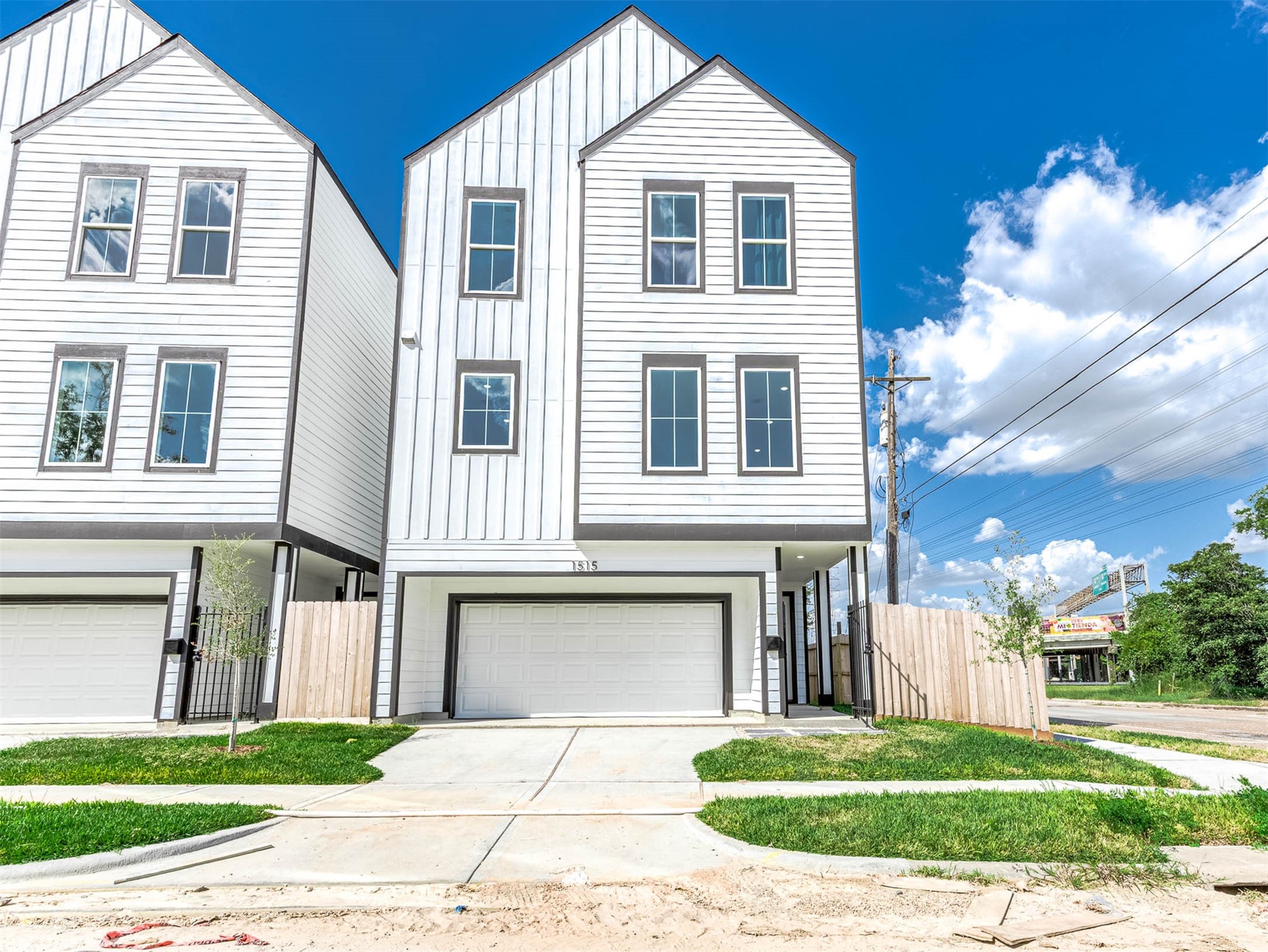1515 Euel Street Houston, TX 77009 - Photo 2 of 34 Striking modern townhome exterior featuring clean architectural lines, large windows, and a contemporary white façade that creates a bright and welcoming curb appeal.