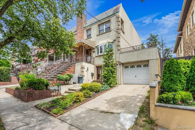 a view of a white house with a yard and plants