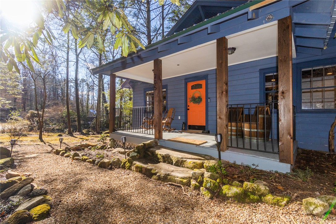 205 Rocky Bottom Road Sunset, SC 29685 - Photo 37 of 46 Natural stone steps lead up to a covered front porch framed by rustic wood pillars.