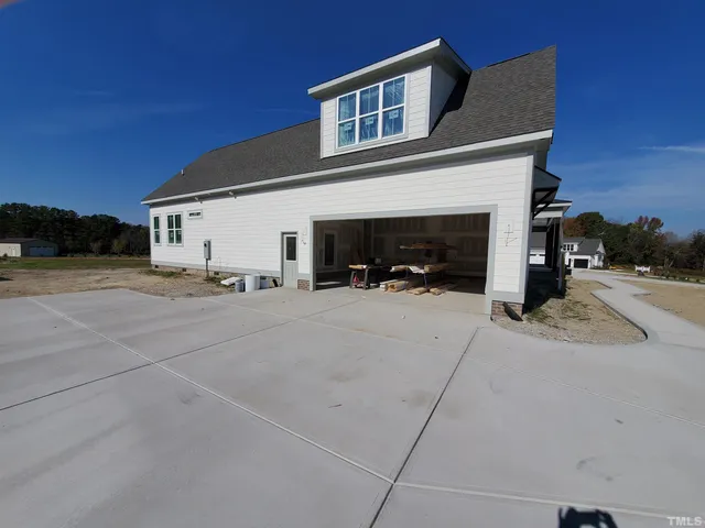 a view of a house with outdoor space and parking