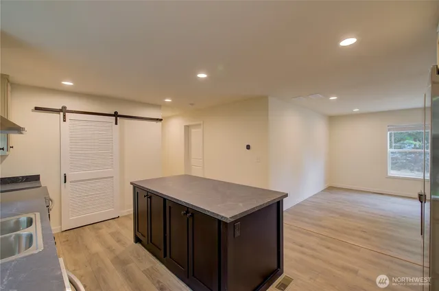 a view of kitchen island wooden floor center island and appliances