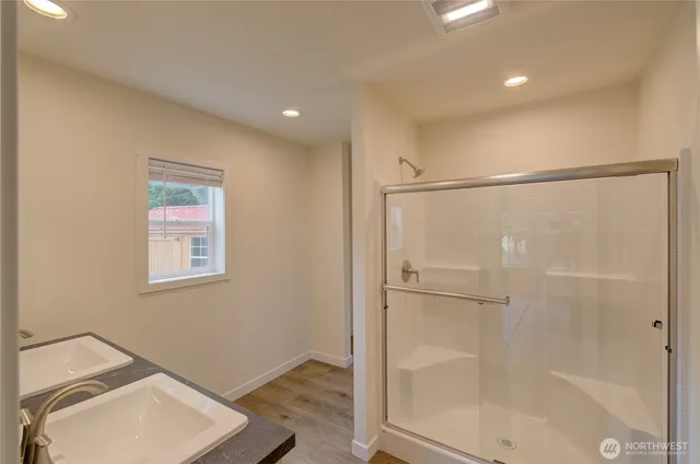 a bathroom with a shower and a sink