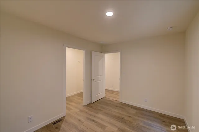 a view of an empty room and wooden floor