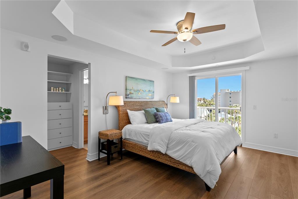 19730 Gulf Boulevard, Unit 400 Indian Rocks Beach, FL 33785 - Photo 56 of 90 a bedroom with a bed and a chandelier