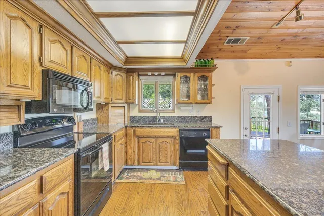 a kitchen with stainless steel appliances granite countertop a stove and a sink