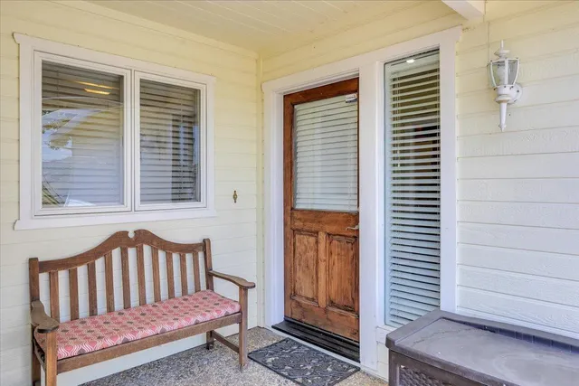 a view of a balcony with two chairs and a table