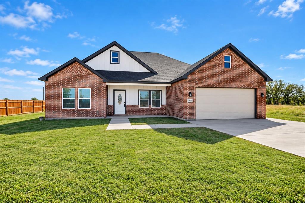 740 Section House Road Alma, TX 75119 - Photo 2 of 4 Brick and siding exterior with a dark roof, attached two-car garage, concrete driveway, and a wood privacy fence