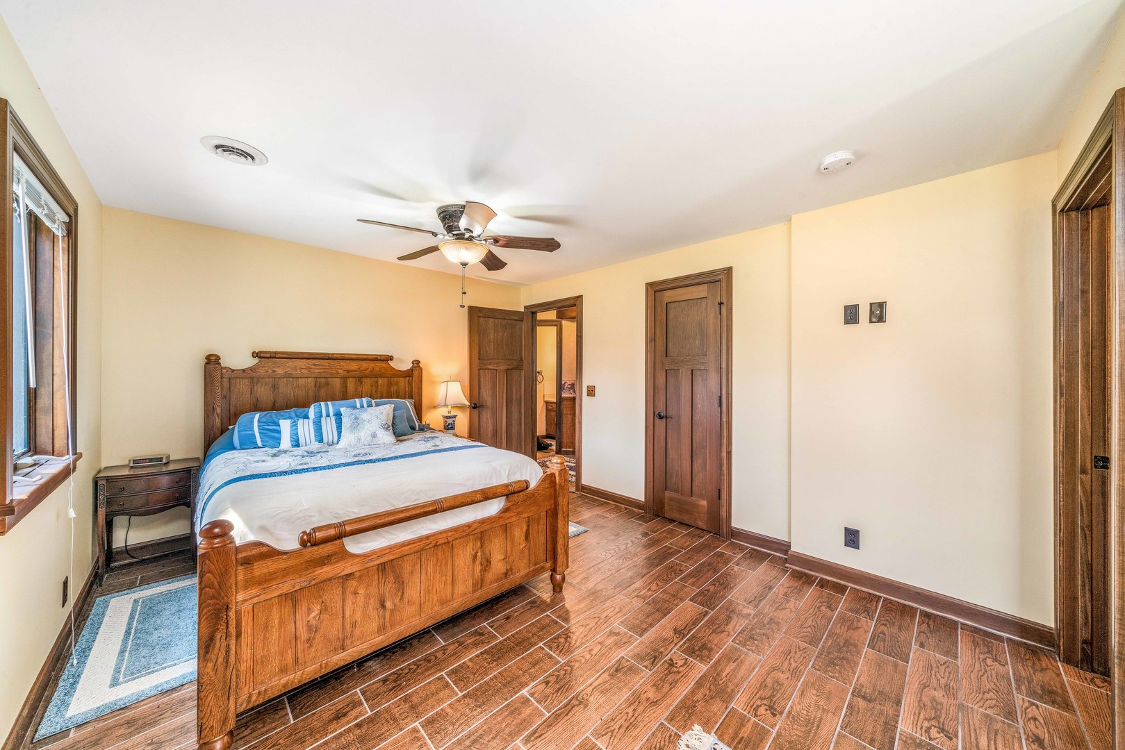 4151 Highway 2 Oregon, IL 61061 - Photo 22 of 30 a bedroom with a bed and a chandelier