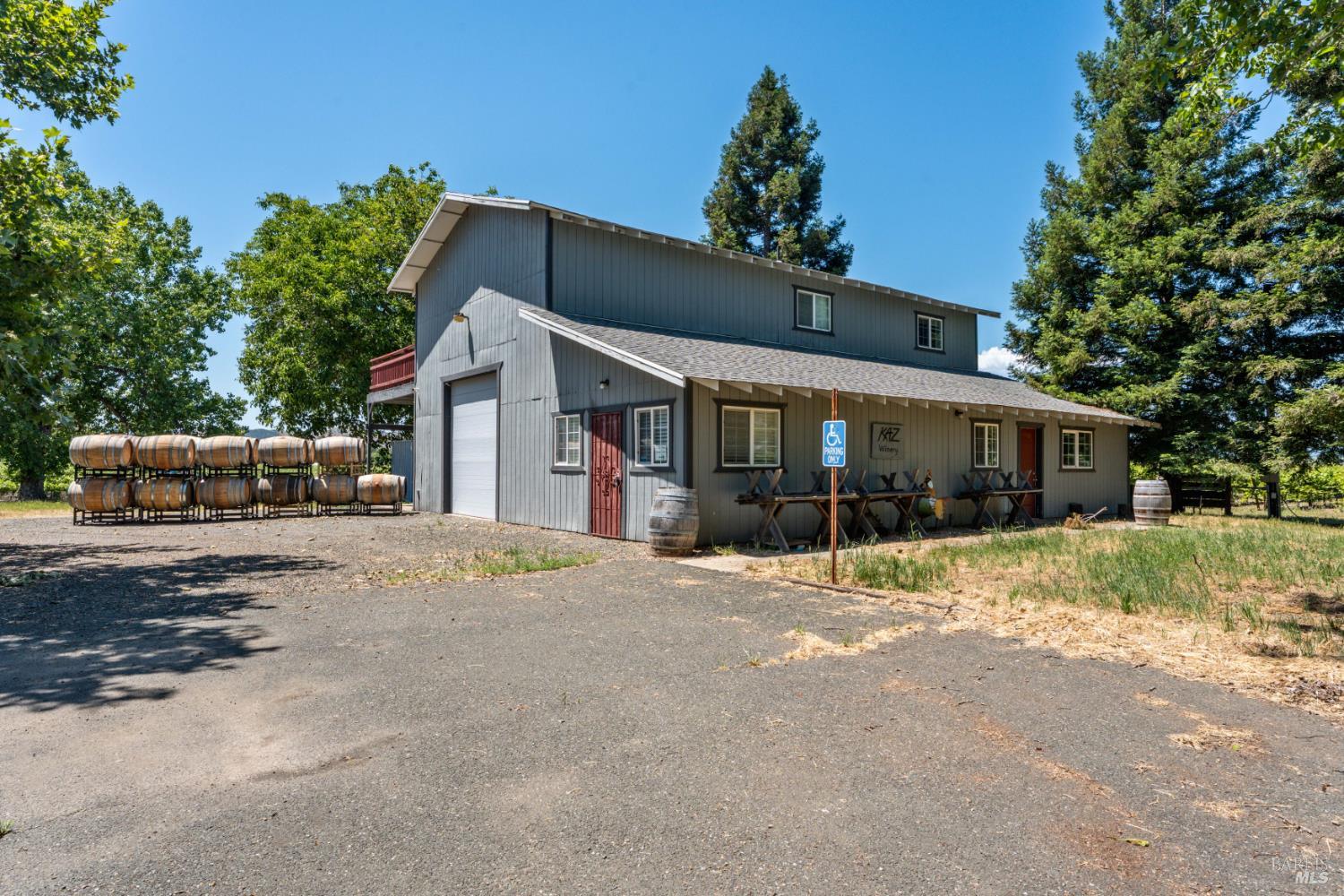1435 Big Valley Road Lakeport, CA 95453 - Photo 7 of 21 a front view of a house with a yard and potted plants