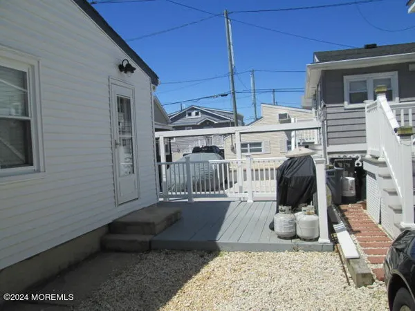 a view of a porch with furniture and barbeque grill