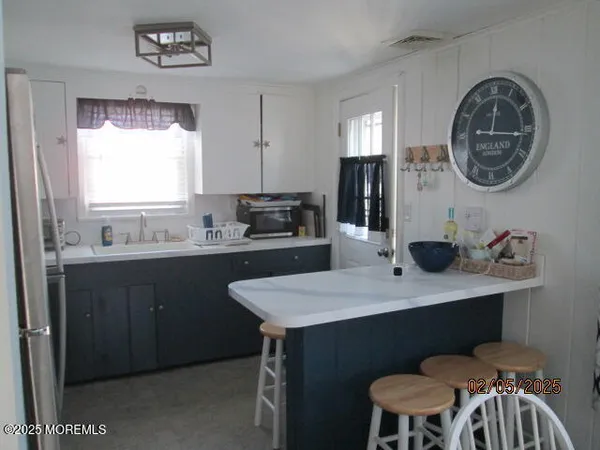 a kitchen with a table chairs a sink and a stove