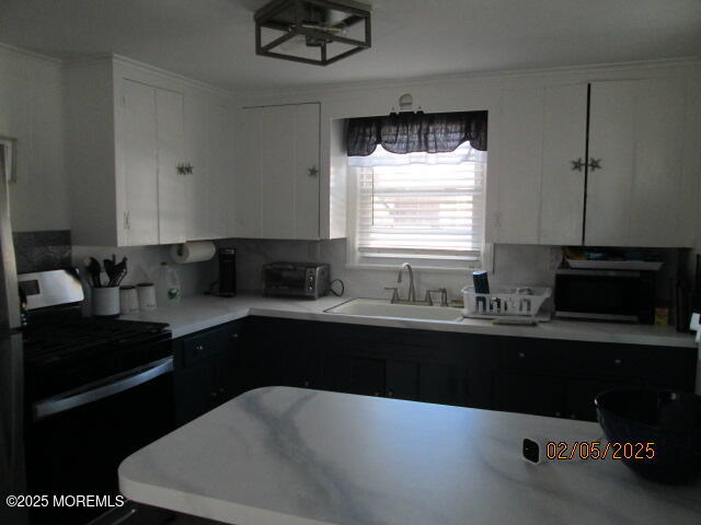 26 Malibu Road Lavallette, NJ 08735 - Photo 5 of 18 a kitchen with a sink a stove and cabinets