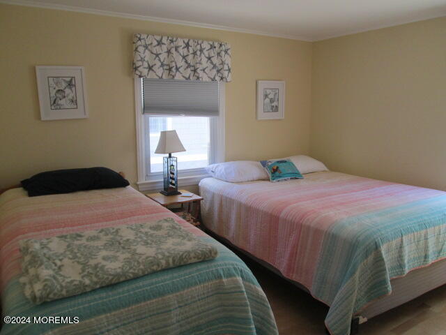 26 Malibu Road Lavallette, NJ 08735 - Photo 10 of 18 a bedroom with two beds and a painting on the wall